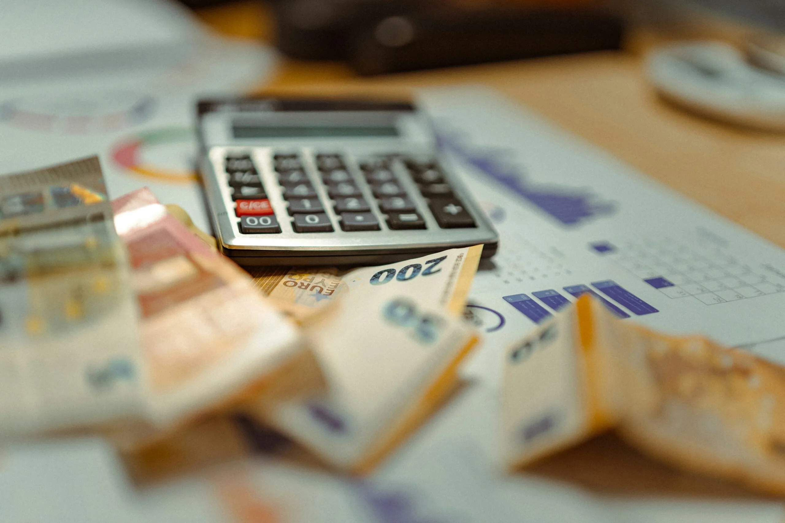 A calculator sitting on top of a pile of money